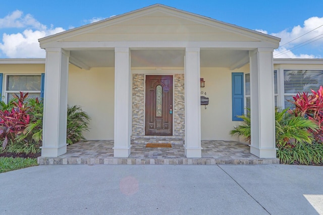 704 Eastwind Dr, North Palm Beach, FL 33408 - doorway to property featuring a porch