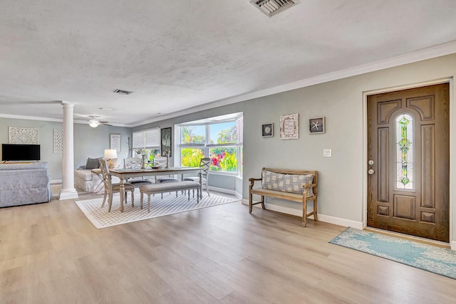 704 Eastwind Dr, North Palm Beach, FL 33408 - dining area featuring light wood finished floors, visible vents, decorative columns, and a healthy amount of sunlight