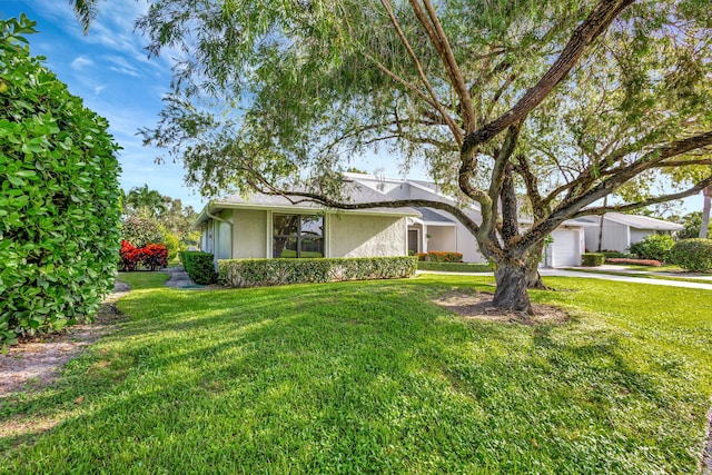 single story home with a front lawn and a garage