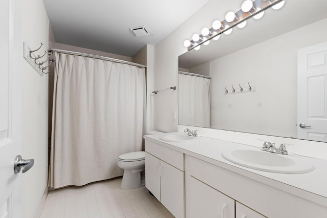 bathroom featuring vanity, a shower with shower curtain, and toilet