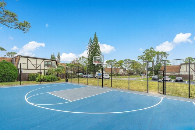 view of basketball court with a yard