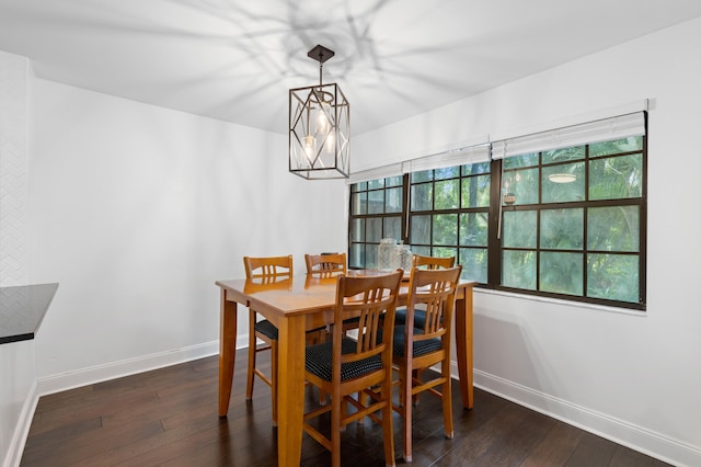 dining space with an inviting chandelier and dark hardwood / wood-style floors