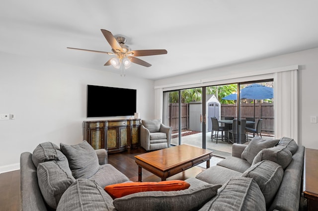 living room with ceiling fan and dark hardwood / wood-style flooring