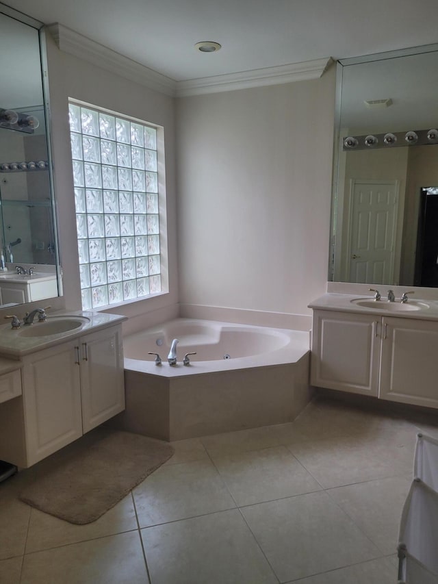 bathroom featuring tile patterned floors, a washtub, crown molding, and vanity