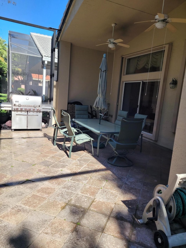 view of patio / terrace with glass enclosure, ceiling fan, and grilling area