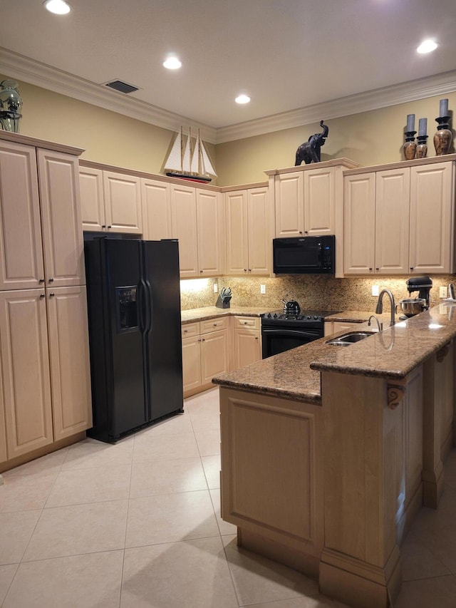 kitchen with kitchen peninsula, decorative backsplash, ornamental molding, black appliances, and stone countertops