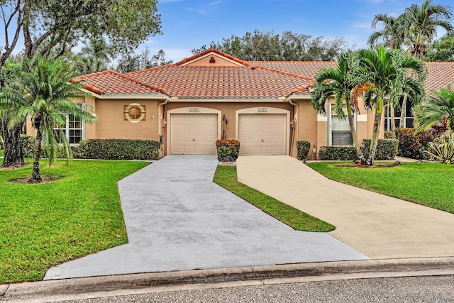 mediterranean / spanish house featuring a front lawn and a garage