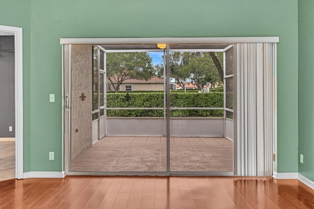 doorway with a healthy amount of sunlight and wood-type flooring