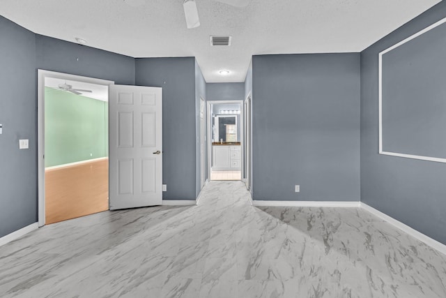 spare room featuring a textured ceiling and ceiling fan