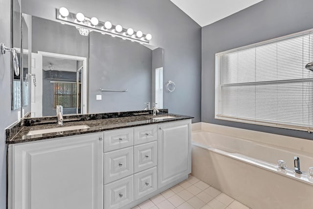 bathroom with vanity, tile patterned floors, and a bathing tub