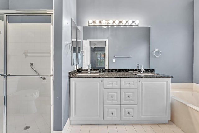 full bathroom featuring vanity, toilet, tile patterned flooring, and plus walk in shower