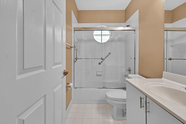 full bathroom featuring vanity, toilet, tile patterned floors, and shower / bath combination with glass door