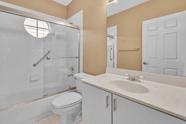 full bathroom with vanity, combined bath / shower with glass door, toilet, and tile patterned flooring