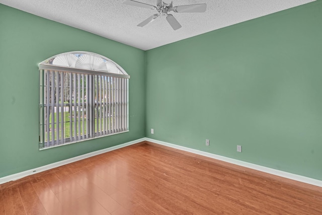 spare room featuring a textured ceiling, hardwood / wood-style flooring, and ceiling fan