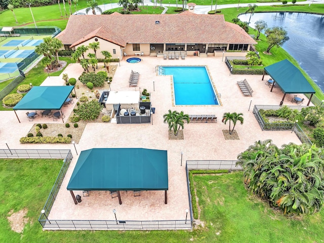 view of swimming pool with a patio, a water view, and a yard