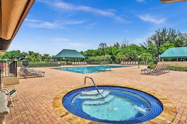 view of pool featuring a gazebo, a hot tub, and a patio