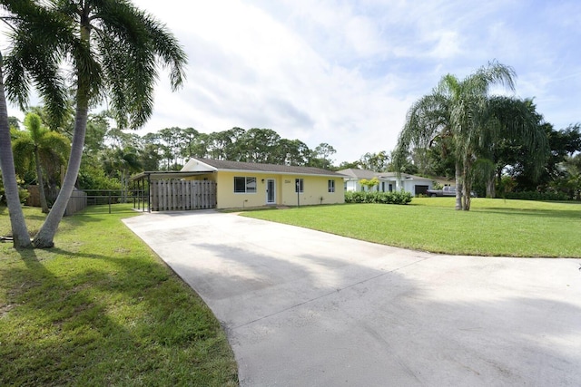 ranch-style house with a front yard and a carport