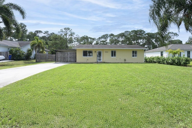 ranch-style home featuring a front lawn and a carport