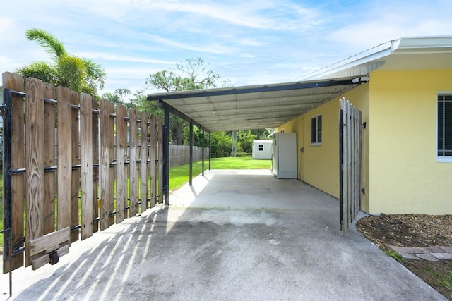 view of car parking featuring a carport and a lawn