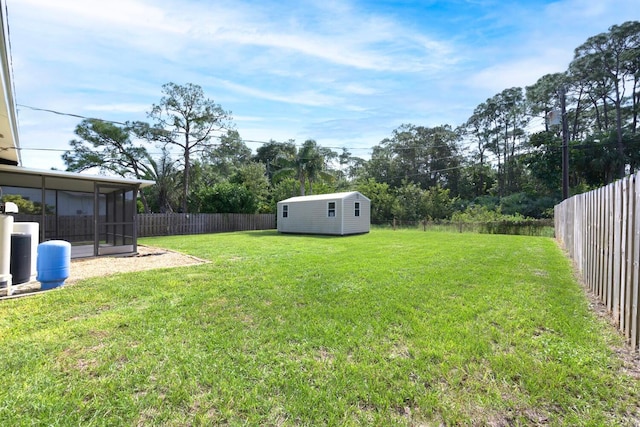 view of yard featuring a sunroom and a storage shed