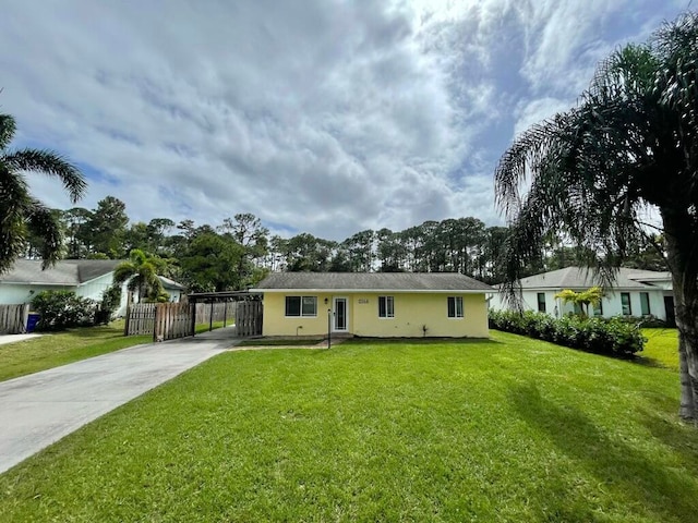 single story home with a front lawn and a carport