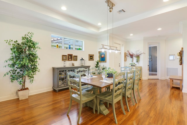 dining room with ornamental molding and hardwood / wood-style floors