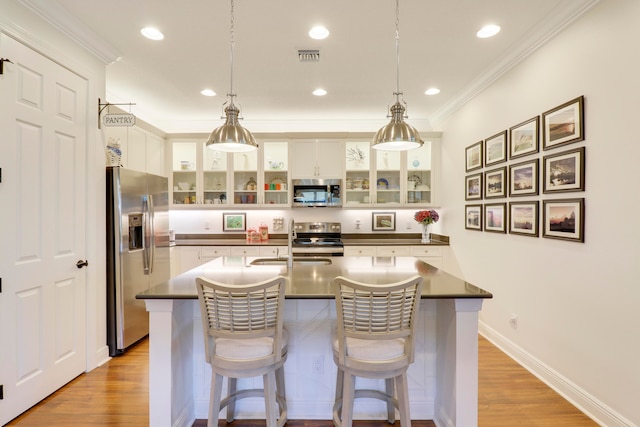 kitchen featuring white cabinetry, light hardwood / wood-style floors, and appliances with stainless steel finishes