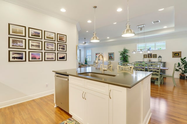 kitchen with white cabinets, dishwasher, sink, and a wealth of natural light