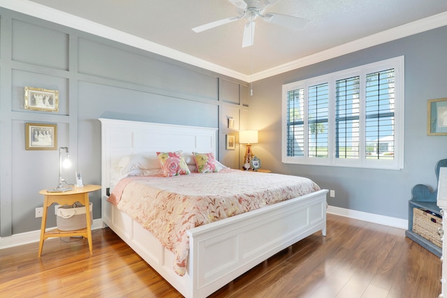 bedroom with hardwood / wood-style floors, crown molding, and ceiling fan