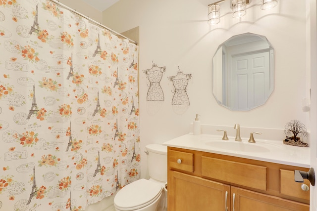 bathroom with vanity, toilet, and walk in shower