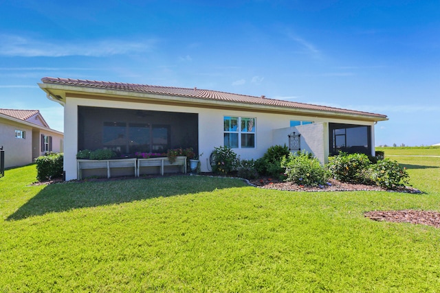 rear view of house with a lawn