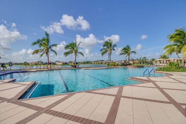 view of pool featuring a patio area and a water view