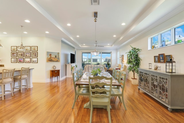 dining room featuring ornamental molding and light wood-type flooring