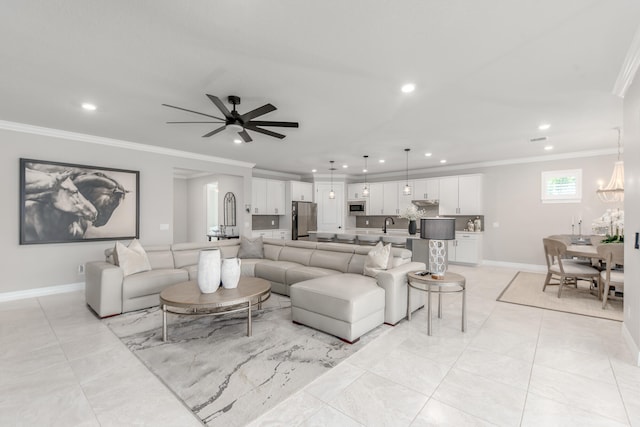 living room with ornamental molding and ceiling fan with notable chandelier