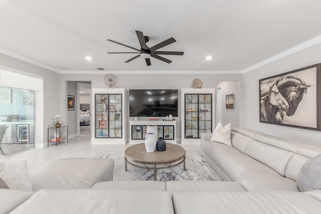 living room with ceiling fan and ornamental molding