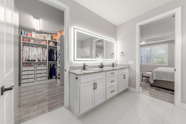 bathroom featuring vanity, a textured ceiling, tile patterned flooring, and ceiling fan