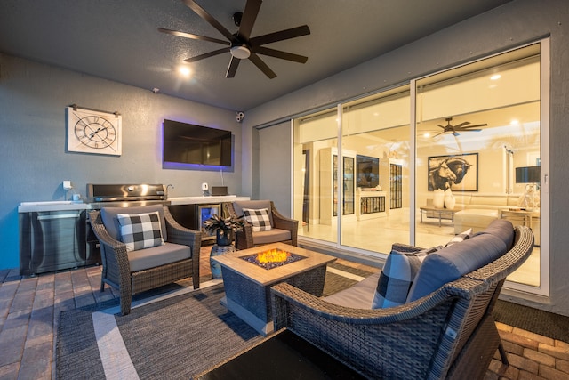 view of patio with ceiling fan and an outdoor living space with a fire pit