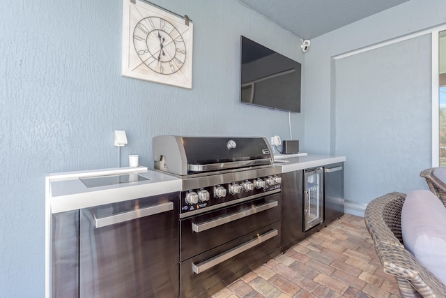 view of patio / terrace with wine cooler, an outdoor kitchen, and a grill