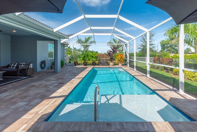 view of swimming pool with a patio and a lanai