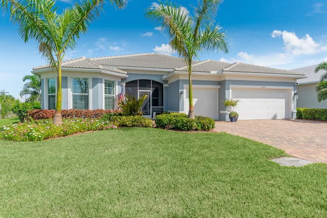 view of front facade with a front yard and a garage