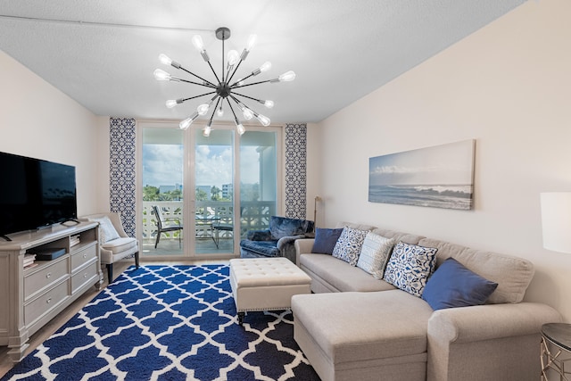 living room with an inviting chandelier, a textured ceiling, and wood-type flooring