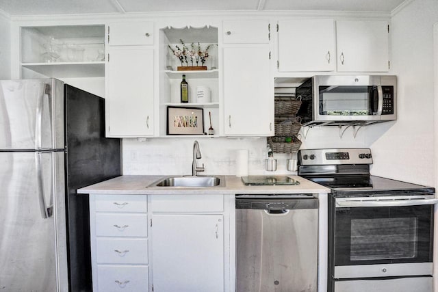 kitchen featuring white cabinets, sink, stainless steel appliances, and ornamental molding