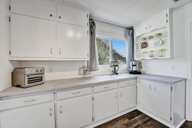 kitchen with a toaster, white cabinets, and light countertops