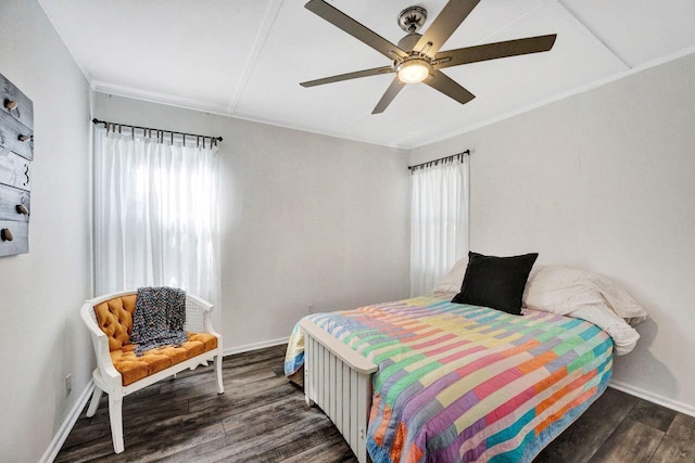 bedroom with a ceiling fan, multiple windows, wood finished floors, and baseboards
