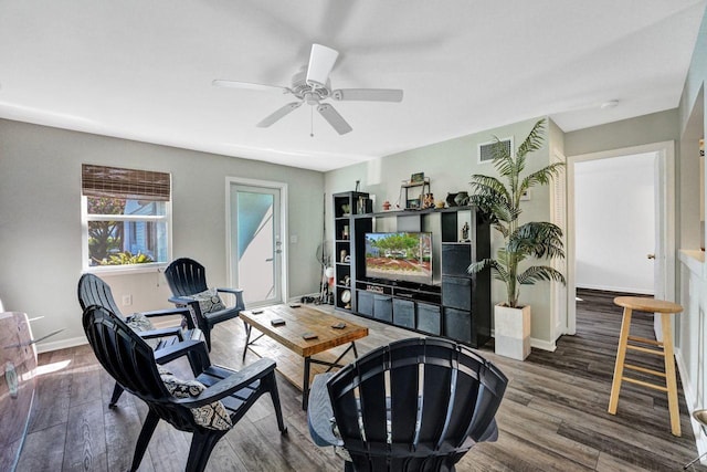 living room featuring ceiling fan and hardwood / wood-style flooring