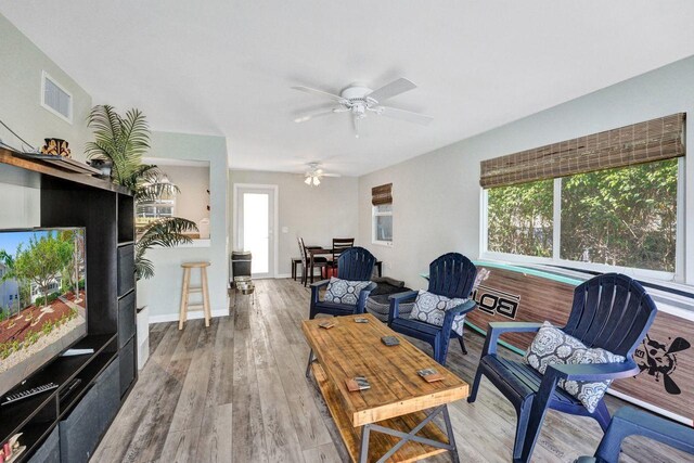 living room featuring ceiling fan and hardwood / wood-style floors