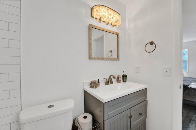 bathroom with toilet, ensuite bathroom, and vanity
