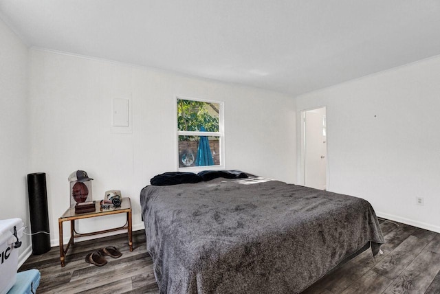 bedroom with dark hardwood / wood-style flooring