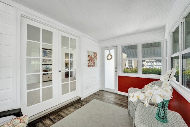 sunroom / solarium featuring french doors