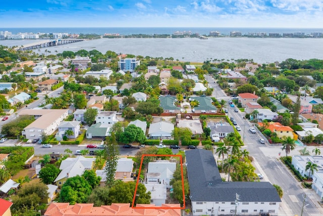 drone / aerial view with a water view and a residential view